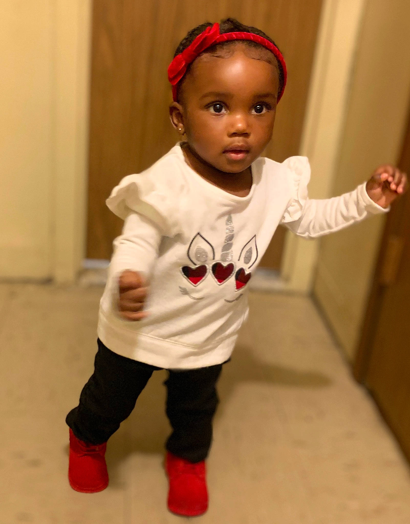 Regina is registered to the contest to win money with this photo: arm, baby, baby_toddler_clothing, cheek, eyelash, face, flooring, gesture, happy, head, headgear, human_body, joint, leg, lip, neck, nose, outerwear, person, skin