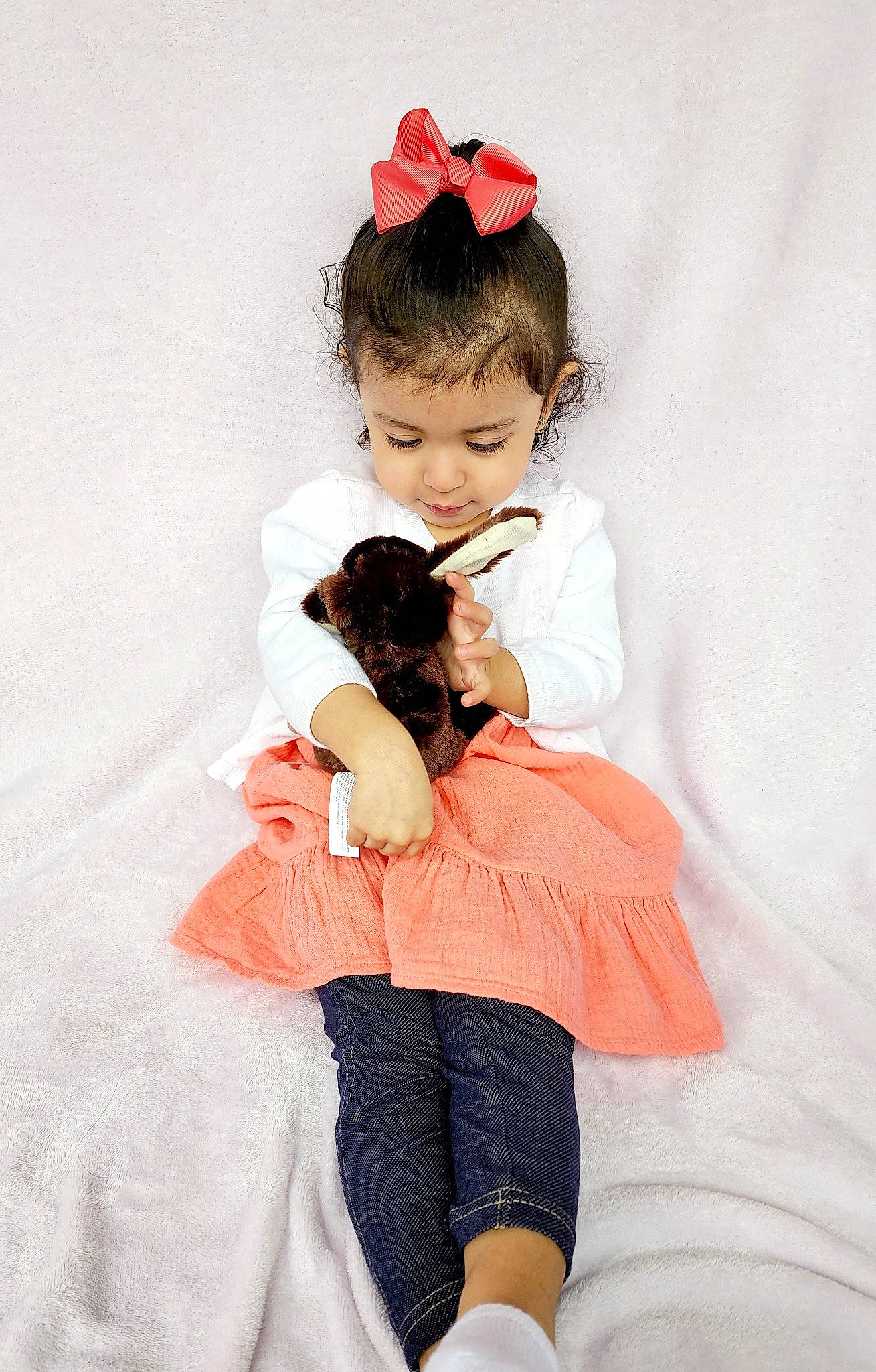 Mia is registered to the contest to win money with this photo: arm, baby_toddler_clothing, black_hair, carnivore, comfort, day_dress, dress, eye, fawn, gesture, hair, happy, head, human_body, leg, neck, person, pink, shoulder, sleeve