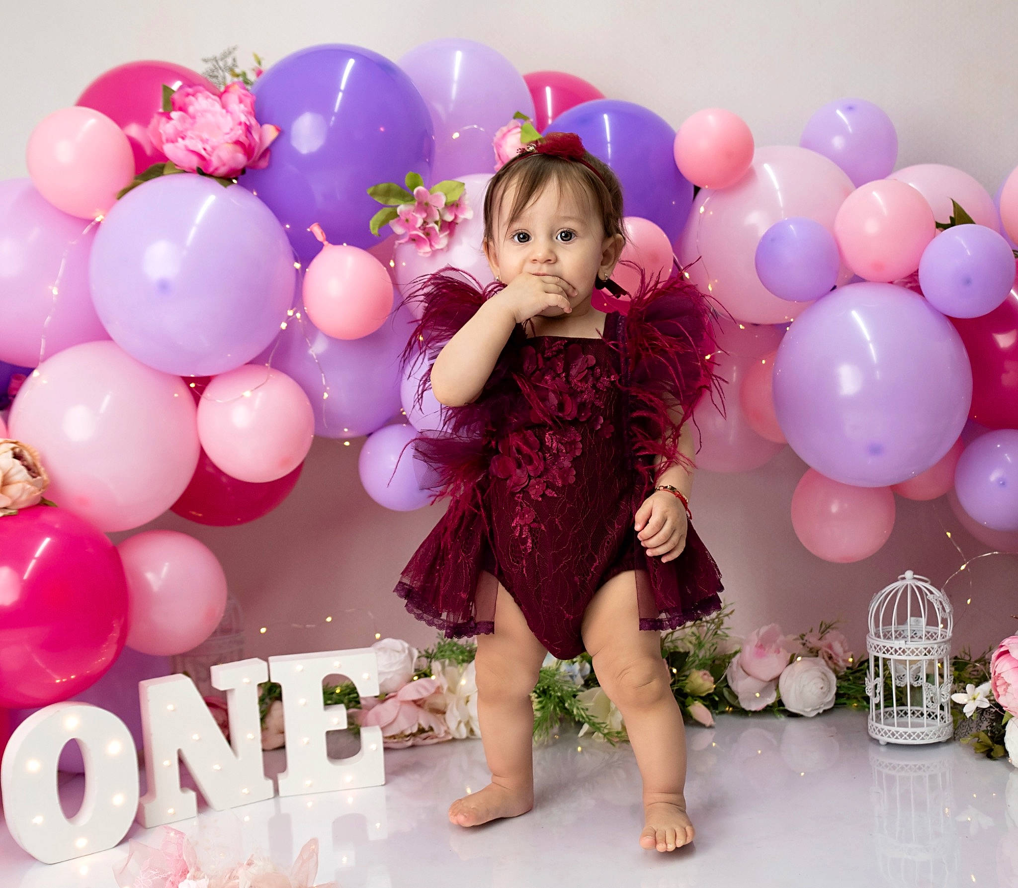 Aniya is registered to the contest to win money with this photo: baby_toddler_clothing, balloon, dress, facial_expression, fashion, finger, fun, hairstyle, happy, head, human, magenta, person, pink, purple, skin, sleeve, standing, textile, toddler
