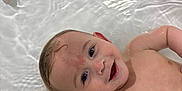 Dexter is registered to the contest to win money with this photo: arm, baby, bath, bathtub, child, childhood, clean, cute, face, floating, happy, head, indoors, infant, playful, relaxing, skin, smile, toy, water