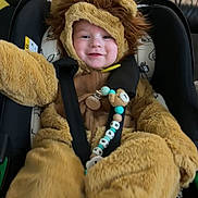 Dexter joined the competition — help win amazing prizes! baby, baby_toy, car_seat, child, comfort, costume, cute, face, fuzzy, happy, indoors, infant, lion_costume, plush, portrait, seat, smiling, straps, warm, young_child