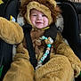 baby, baby_toy, car_seat, child, comfort, costume, cute, face, fuzzy, happy, indoors, infant, lion_costume, plush, portrait, seat, smiling, straps, warm, young_child