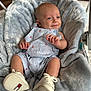 Silas joined the competition — help win amazing prizes! baby, infant, smile, romper, baby_shoes, cushion, blanket, indoor, child, happy, face, cute, soft_texture, seated, clothing, footwear, newborn, person, baby_boy, cozy