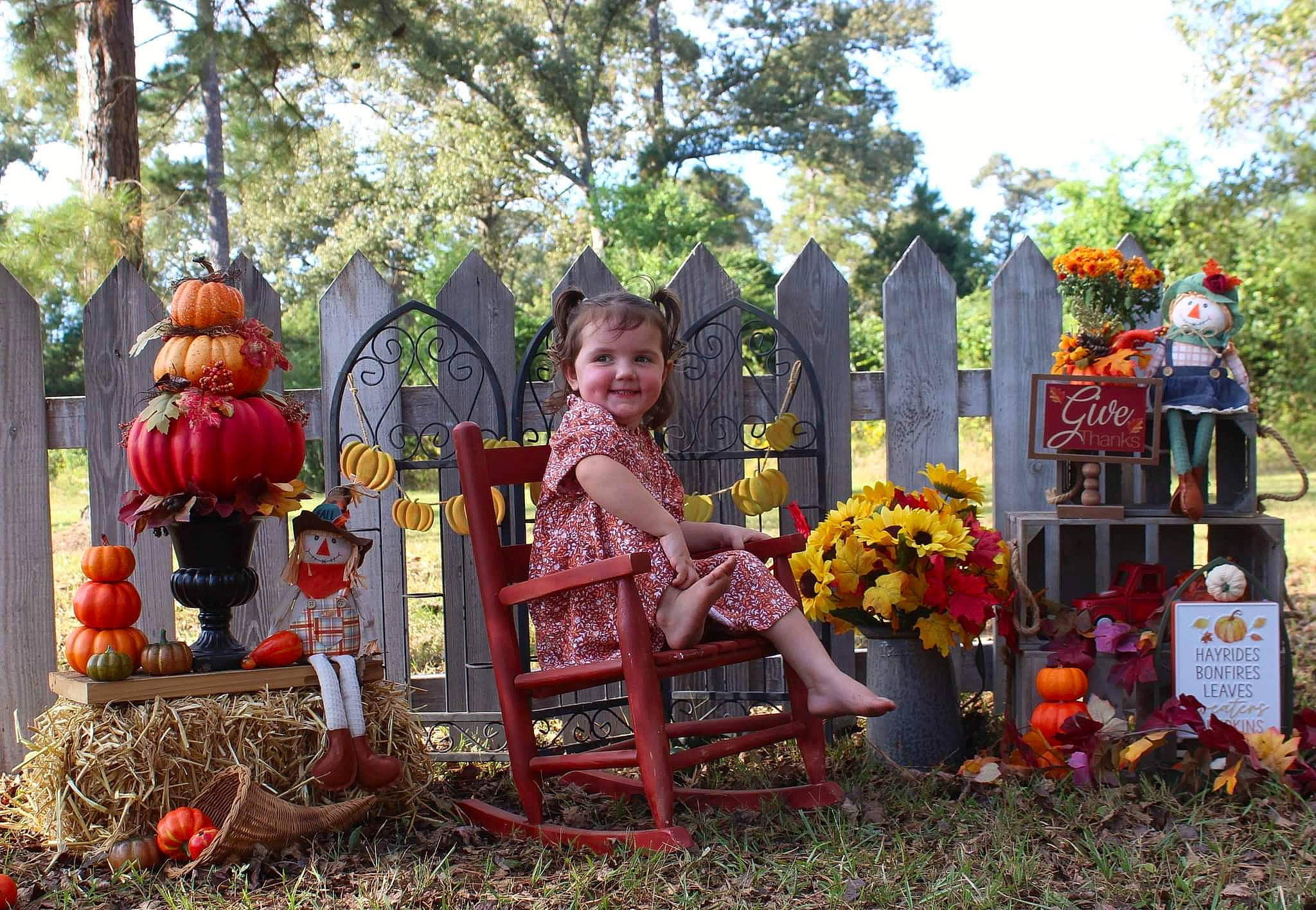 Brycelynn is registered to the contest to win money with this photo: calabaza, chair, event, flower, fun, garden, gourd, grass, joy, landscaping, lawn_ornament, leaf, leisure, person, plant, pole, pumpkin, rose, shrub, sky