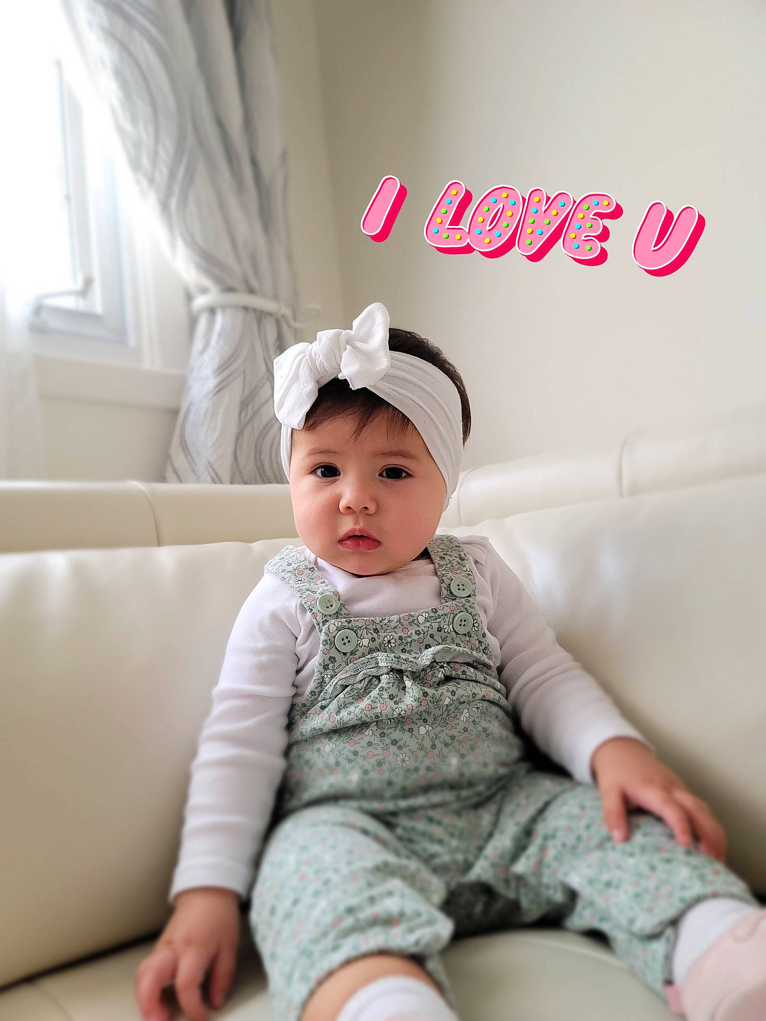 Charlotte is registered to the contest to win money with this photo: baby, baby_toddler_clothing, bonnet, child, comfort, costume_accessory, couch, curtain, hair_accessory, headband, headpiece, headwear, interior_design, living_room, mouth, person, pink, sock, sofa_bed, toddler