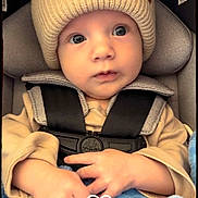 River joined the competition — help win amazing prizes! baby, infant, beanie, hat, car_seat, seat_belt, buckle, straps, blanket, blue_blanket, hands, wide_eyes, face, close_up, portrait, cute, baby_clothing, padded_headrest, sticker_heart, soft_texture