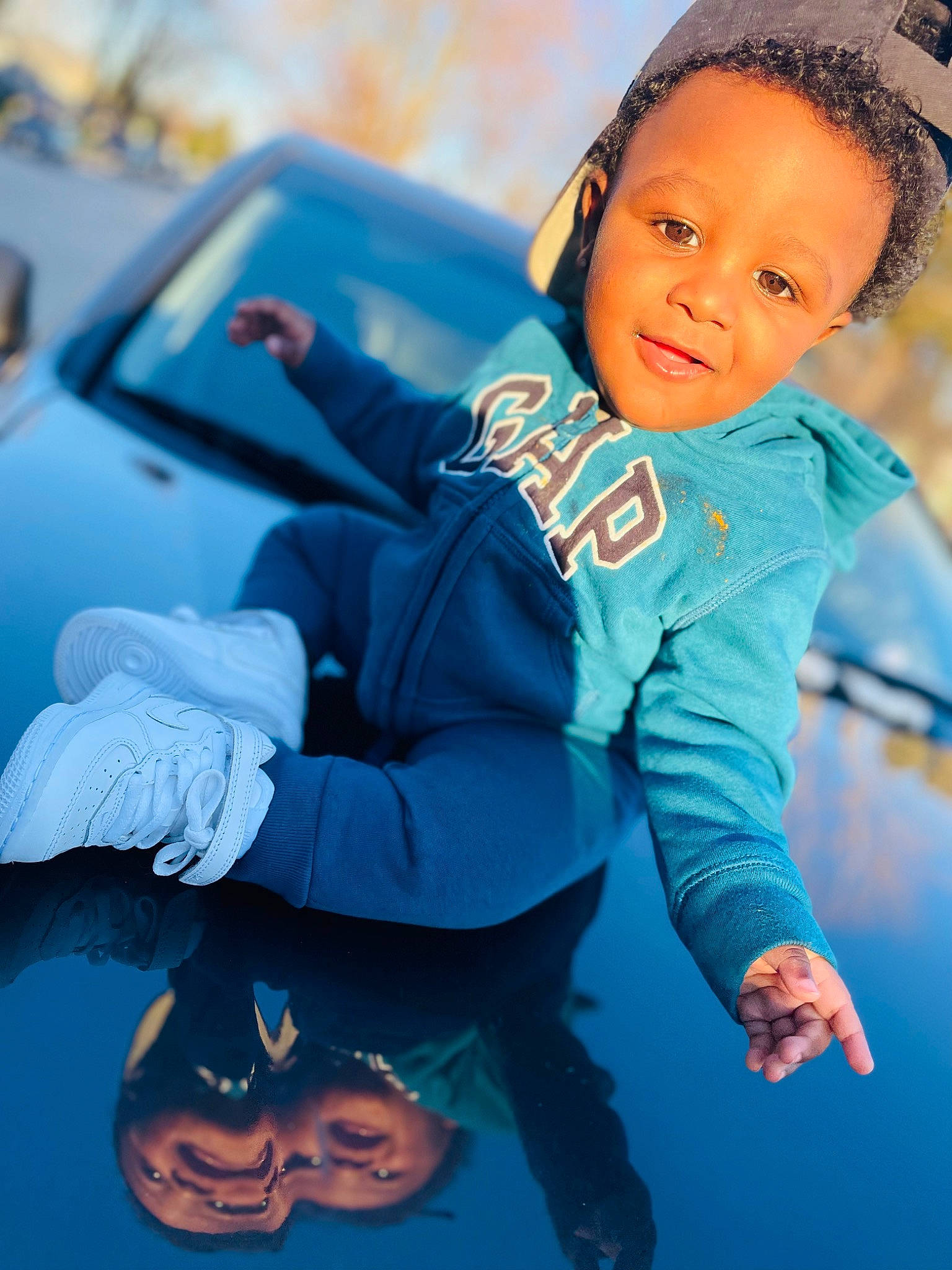 Kaidyn Blackburn is registered to the contest to win money with this photo: aqua, azure, baby_toddler_clothing, blue, cloud, cool, electric_blue, flash_photography, fun, gesture, grass, happy, leisure, outdoor_play_equipment, people_in_nature, person, recreation, sitting, smile, swing