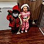 Zayah joined the competition — help win amazing prizes! cabinet, child, christmas, decoration, doll, festive, floor, furniture, hat, holiday, indoor, person, pink_dress, room, santa_claus, scroll, shoes, standing, toy, wooden_floor