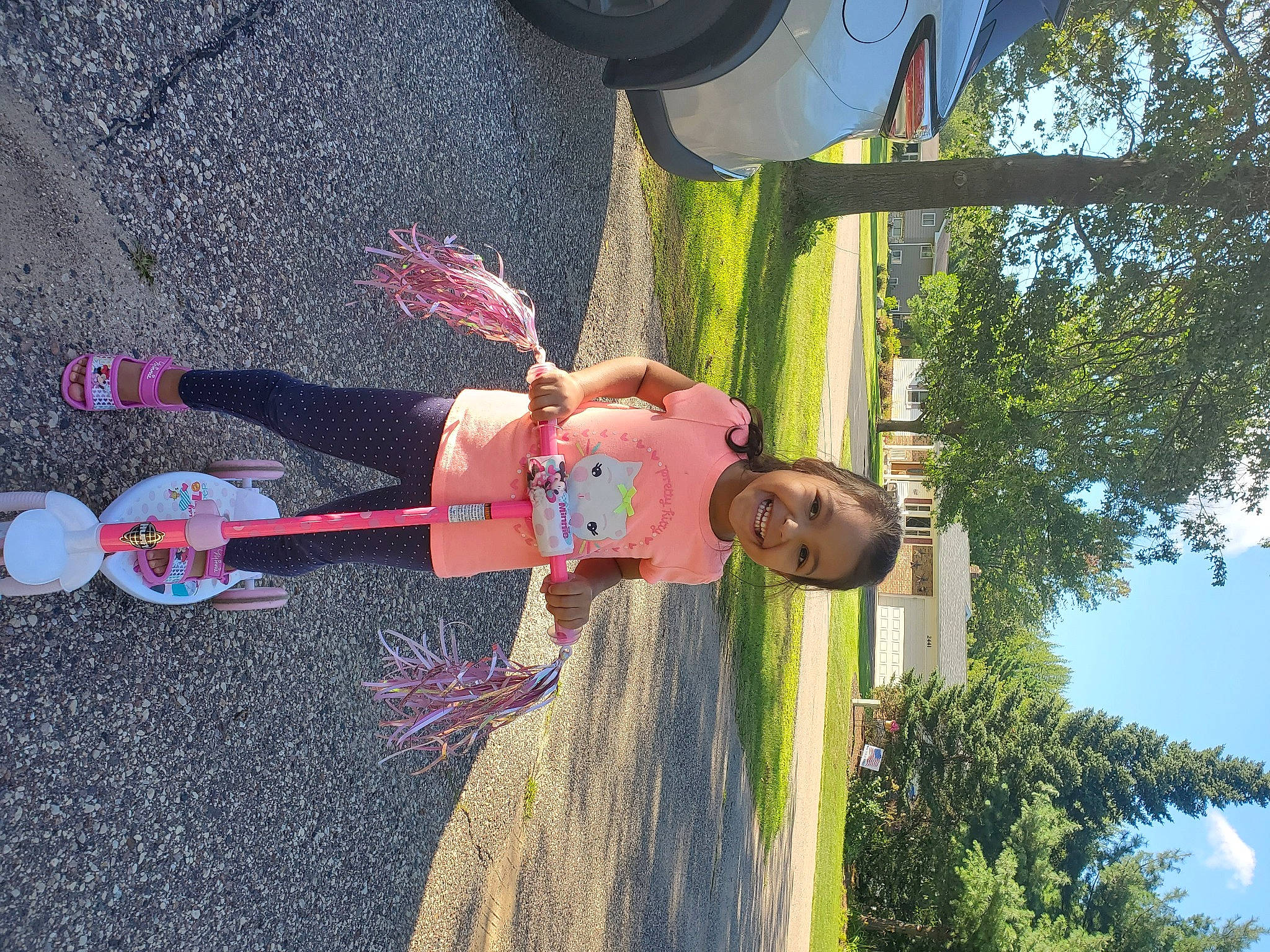 Laura Sophia joined the competition — help win amazing prizes! asphalt, child, city, fun, happy, joy, leisure, light, line, outdoor_play_equipment, person, pole, recreation, road_surface, sky, smile, tire, toddler, tree, vehicle