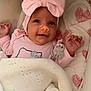 Suzanna is registered to the contest to win money with this photo: accessories, baby, bed, blanket, bonnet, clothing, crib, face, furniture, happy, hat, head, infantbed, jewelry, necklace, newborn, person, photography, portrait, quilt