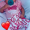 baby, pacifier, headband, pink_clothing, heart_pattern, blanket, infant, cute, sleepwear, child, soft_texture, relaxing, indoors, portrait, lying_down, cozy, adorable, small_hand, foot, red_heart_emoji