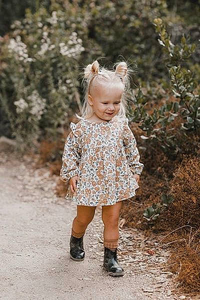 Evangeline is registered to the contest to win money with this photo: blond, boot, child, child_model, dress, footwear, joint, outerwear, pattern, people, person, photograph, photography, portrait_photography, shoulder, skin, sleeve, standing, textile, toddler