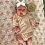 Willow joined the competition — help win amazing prizes! baby, blanket, bow, child, clothing, cute, face, happy, headband, infant, lying_down, newborn, one_month, pattern, pink, portrait, smiling, socks, white, wooden_plaque