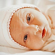 Willow is registered to the contest to win money with this photo: baby, baby_face, blanket, cap, closeup, cute, eyes, face, hat, infant, innocence, lying_down, newborn, newborn_clothing, pink_trim, portrait, skin, sleepwear, soft, white