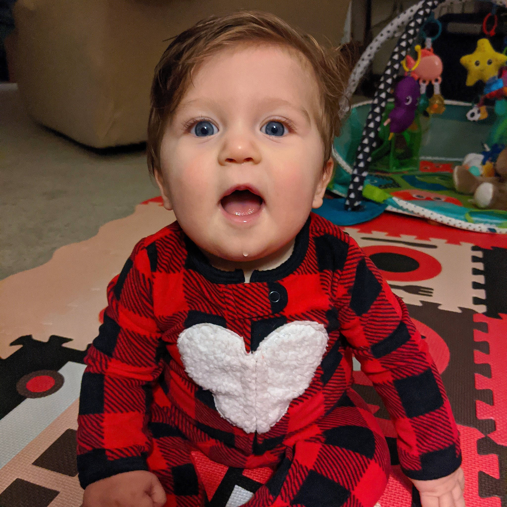 Samuel is registered to the contest to win money with this photo: baby, cheek, child, design, eye, face, facial_expression, head, mouth, pattern, person, plaid, play, smile, surprise, tartan, textile, toddler