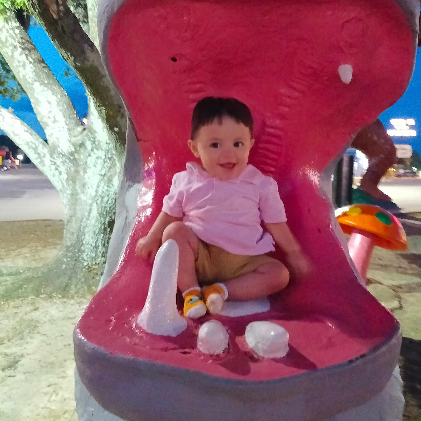 Steven is registered to the contest to win money with this photo: child, colorful, evening, fun, happy, hippo, mouth, mushroom, nature, outdoor, park, person, playground, playtime, sculpture, smiling, statue, toddler, toy, tree