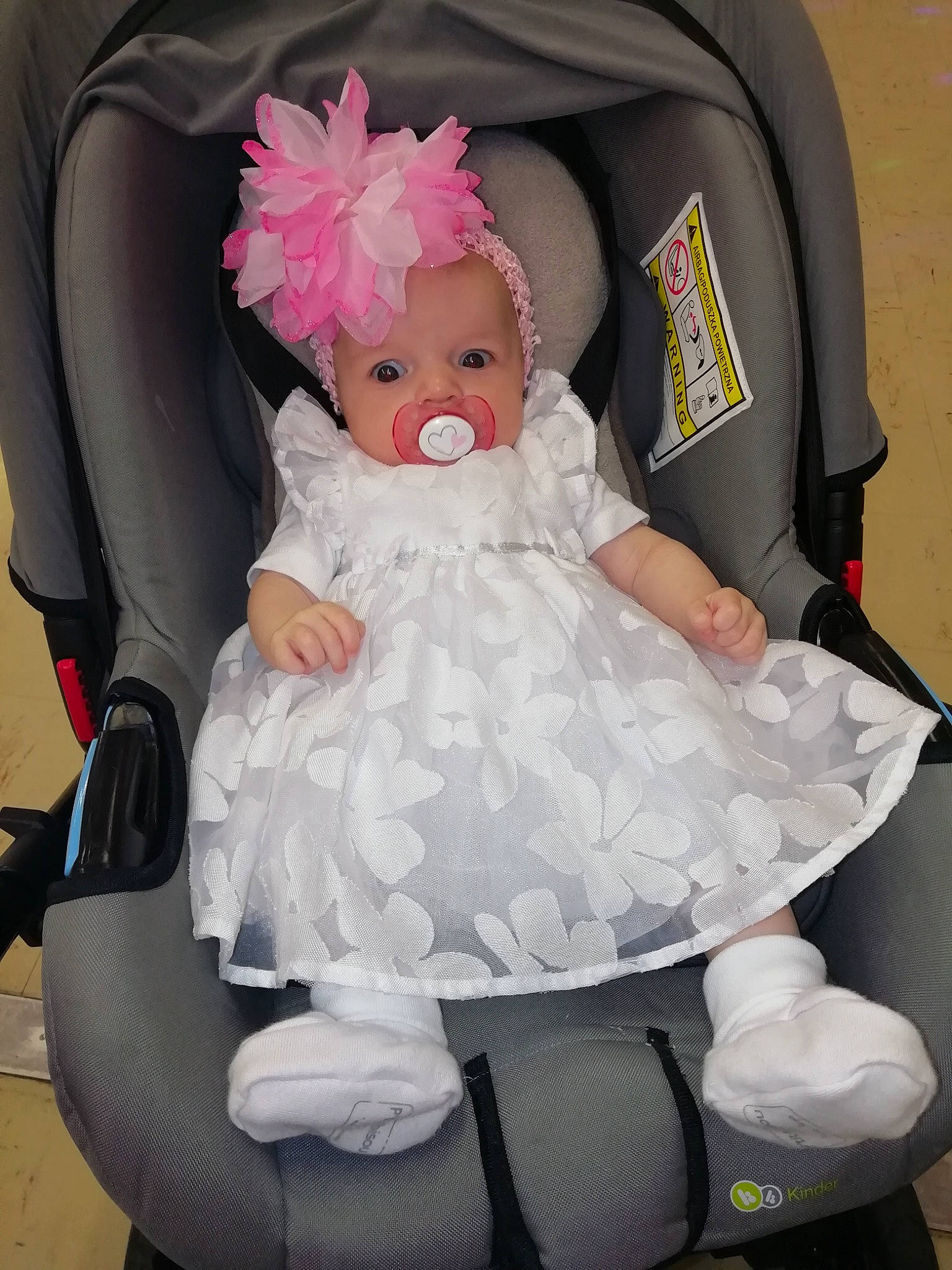 Kelya participe au concours pour gagner de l'argent avec cette photo : baby, baby_products, baby_toddler_clothing, black, chair, child, comfort, costume_hat, head, headpiece, headwear, lap, person, pink, product, sitting, smile, textile, toddler, toy