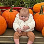 autumn, baby, brown_pants, child, curious, cute, face, fall, fluffy_jacket, greenery, hand, harvest, nature, orange, outdoor, pumpkin, rustic, seasonal, sitting, wagon