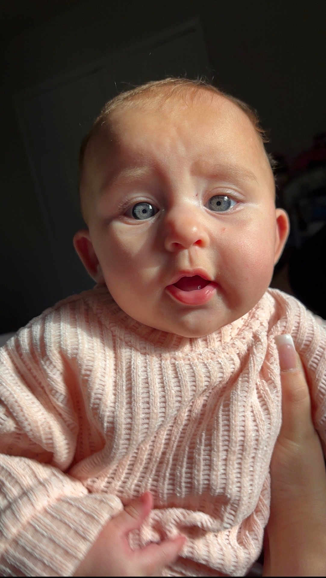Athena joined the competition — help win amazing prizes! baby, child, face, blue_eyes, sweater, knitwear, hand, skin, cute, indoor, portrait, expression, fingernails, person, infant, young_child, warm_clothing, closeup, soft_light, curious
