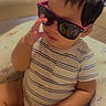 toddler, child, sunglasses, striped_shirt, indoor, toy, playpen, cute, baby, reflection, hand, sitting, short_hair, casual, infant, funny, portrait, person, glasses, comfortable