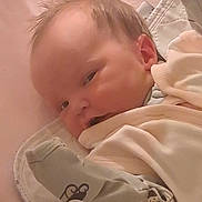 Ellie joined the competition — help win amazing prizes! baby, blanket, child, clothing, cute, face, head, indoors, infant, lying_down, newborn, nursery, pajamas, person, resting, skin, sleepy, soft, warm, young