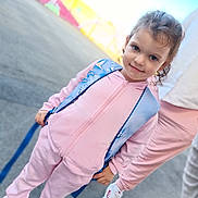 Talya participe au concours pour gagner de l'argent avec cette photo : child, girl, pink_tracksuit, blue_backpack, outdoor, smiling, person, sneakers, concrete, mural, colorful, casual_clothing, young, standing, happy, daylight, hair_tied, urban, playful, cute