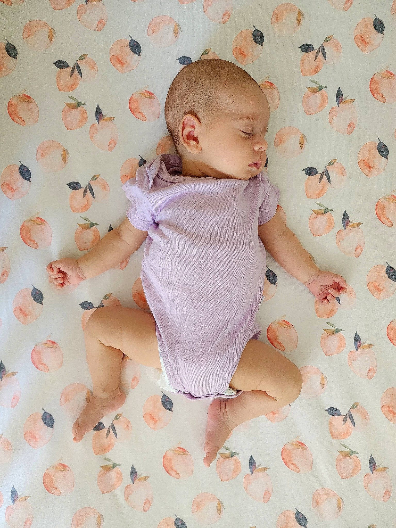 Emilia is registered to the contest to win money with this photo: arm, baby, baby_toddler_clothing, beauty, child, comfort, foot, happy, infant_bodysuit, one_piece_garment, pattern, peach, person, pink, product, sitting, skin, sleeve, thumb, toddler