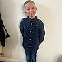 child, boy, smile, standing, blue_shirt, jeans, sneakers, indoor, wall, casual_clothing, short_hair, pose, happy, portrait, person, footwear, floor, young, buttoned_shirt, light