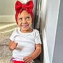 Jazmynn joined the competition — help win amazing prizes! child, toddler, red_bow, headwrap, smile, sitting, stairs, indoor, white_shirt, patriotic_shorts, american_flag, carpet, looking_up, happy, earring, portrait, natural_light, wall, casual_clothing, hands