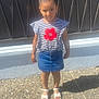 Raissa a rejoint le concours — aidez-le/la à gagner de superbes lots ! child, girl, standing, outdoor, sunlight, shadow, denim_skirt, striped_shirt, red_flower, hair_bun, sandals, concrete, pebble_ground, wall, black_wall, casual_clothing, person, summer, young, fashion