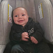 Aaron joined the competition — help win amazing prizes! baby, child, smile, car_seat, clothing, infant, person, happy, seat, indoor, cute, young, apparel, sitting, face, portrait, one_person, childhood, baby_clothes, leisure