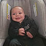 baby, child, smile, car_seat, clothing, infant, person, happy, seat, indoor, cute, young, apparel, sitting, face, portrait, one_person, childhood, baby_clothes, leisure