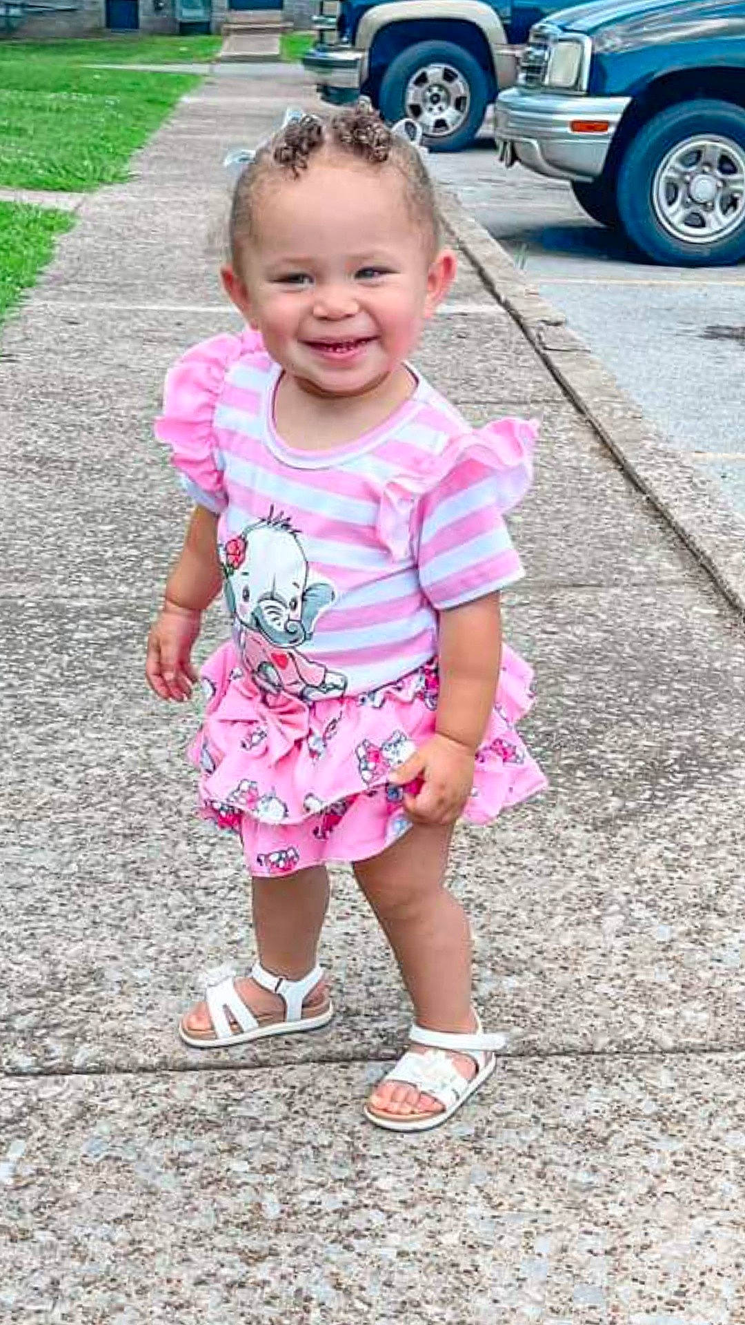 Keilani is registered to the contest to win money with this photo: asphalt, automotive_tire, baby_toddler_clothing, child, face, fun, hairstyle, happy, joy, leg, leisure, magenta, people, person, pink, product, sleeve, smile, tire, toddler