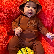 Karter joined the competition — help win amazing prizes! baby, infant, onesie, hood, turkey_costume, pumpkin, orange_blanket, cute, child, portrait, cozy, fall, autumn, holiday, thanksgiving, smiling, lying_down, hand, face, expression