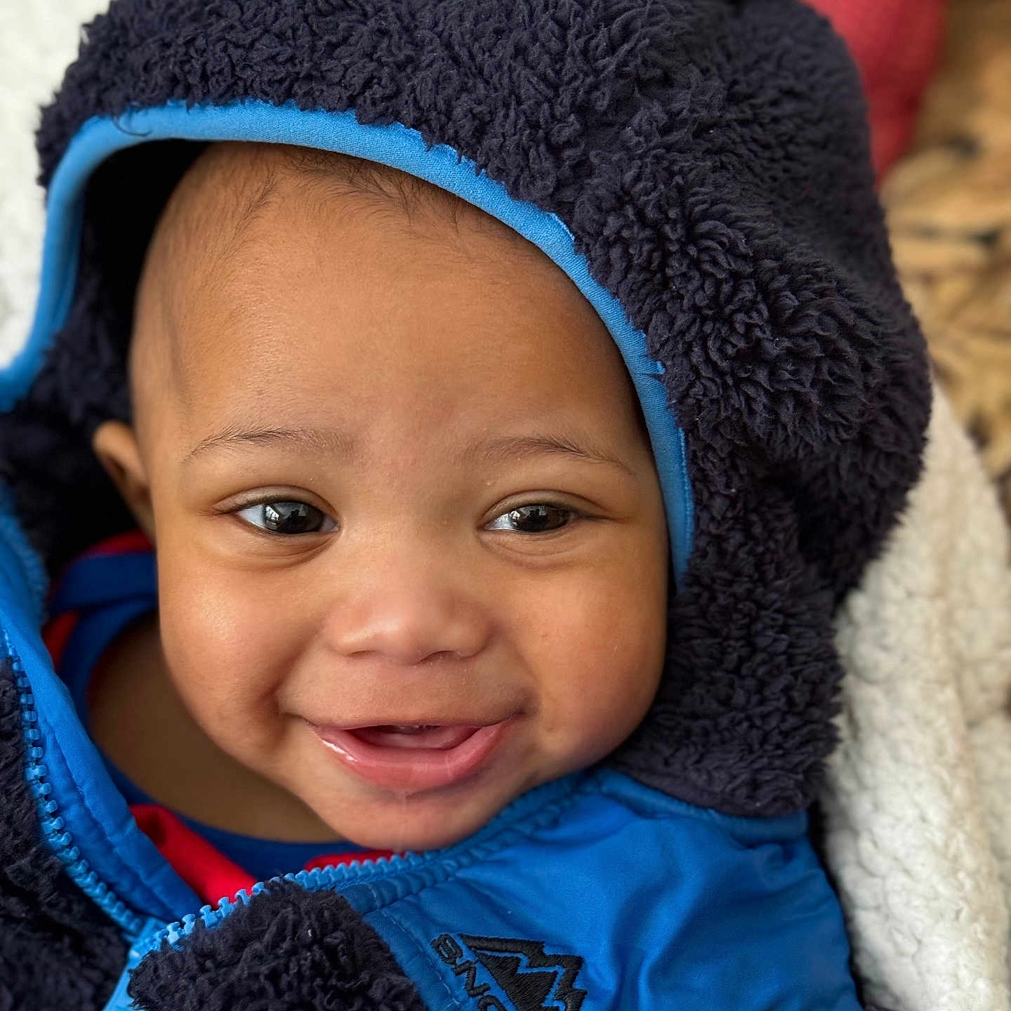 Jacobi joined the competition — help win amazing prizes! baby, bonnet, cap, clothing, coat, face, fleece, happy, hat, head, hood, hoodie, jacket, knitwear, person, photography, portrait, smile, sweater, sweatshirt
