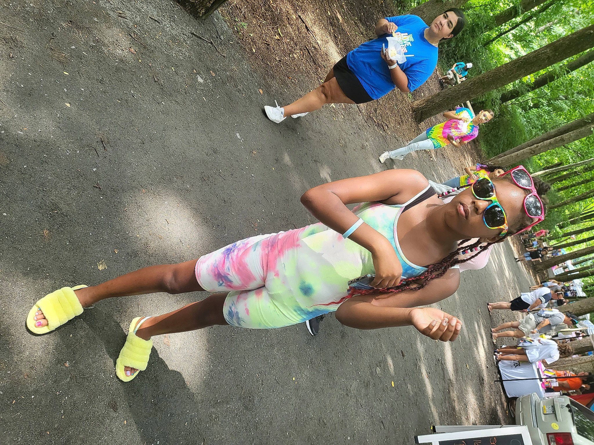 Ida'Jah is registered to the contest to win money with this photo: asphalt, barefoot, eyewear, fun, grass, hat, human_leg, joint, knee, leg, leisure, person, public_space, recreation, sandal, shorts, sneakers, sunglasses, swimwear, t_shirt