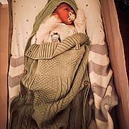 Luca joined the competition — help win amazing prizes! newborn, baby, blanket, crib, pacifier, knitted, hat, sleeping, infant, bed, fabric, soft, striped, star_pattern, cozy, cute, warm, child, resting, sleep