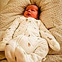 Luca is registered to the contest to win money with this photo: baby, infant, onesie, animal_print, blanket, soft_texture, lying_down, face, head, sleepwear, cute, newborn, child, indoors, comfort, warm, rest, portrait, cozy, peaceful