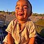 Kenzo joined the competition — help win amazing prizes! toddler, child, smiling, beach, sunlight, sand, blue_sky, blanket, happy, portrait, outdoor, clothing, buttoned_shirt, person, sitting, warm_light, nature, daytime, cute, fun