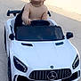 amg, baby, bare_chest, child, cute, daylight, driveway, face, happy, head, luxury_toy, mercedes, outdoor, person, photography, small_vehicle, smiling, toddler, toy_car, white_car