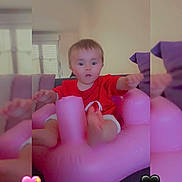 Keyla participe au concours pour gagner de l'argent avec cette photo : toddler, child, inflatable_chair, pink, red_shirt, indoor, couch, cushions, curious, baby, furniture, home, person, expression, heart_emoji, cute, seated, soft_light, living_room, portrait