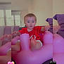 baby, child, couch, curious, cushions, cute, expression, furniture, heart_emoji, home, indoor, inflatable_chair, living_room, person, pink, portrait, red_shirt, seated, soft_light, toddler