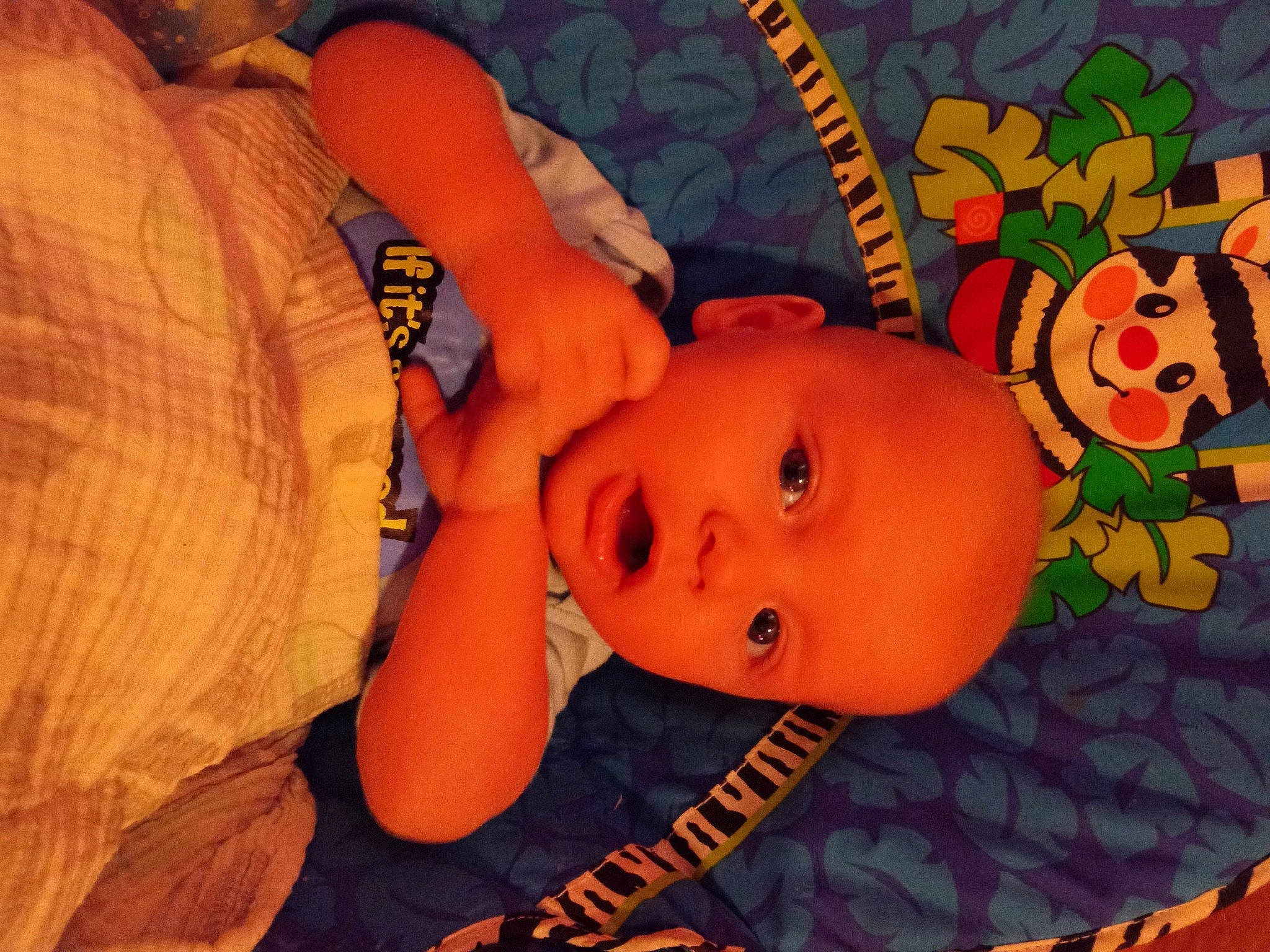 Ryker is registered to the contest to win money with this photo: art, baby, baby_products, baby_toddler_clothing, cheek, child, comfort, fun, happy, head, leisure, mammal, mouth, nose, orange, pattern, person, textile, toddler, vertebrate