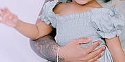 Jade is registered to the contest to win money with this photo: toddler, child, smiling, bow, dress, tattoo, arm, adult, happy, sitting, holding, cute, portrait, indoor, person, fashion, skin, hand, face, joyful