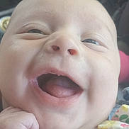 Carla joined the competition — help win amazing prizes! baby, smiling, close_up, face, hand, clothing, bow, polka_dot, infant, joy, happy, child, portrait, cute, skin, mouth, tongue, car_interior, seat, fist