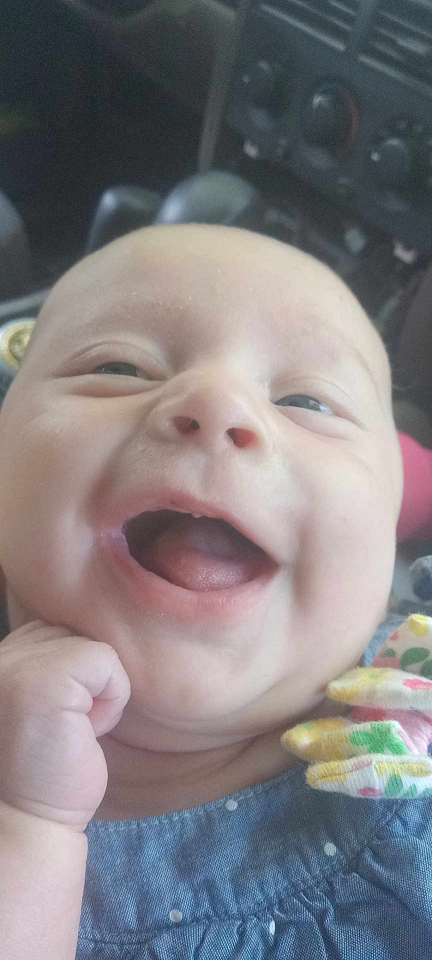 Carla joined the competition — help win amazing prizes! baby, smiling, close_up, face, hand, clothing, bow, polka_dot, infant, joy, happy, child, portrait, cute, skin, mouth, tongue, car_interior, seat, fist