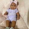 baby, blanket, child, cute, fluffy, happy, headband, indoors, infant, person, pink_bow, portrait, purple_outfit, rainbow_print, shoes, sitting, smile, soft_texture, striped_shoes, young