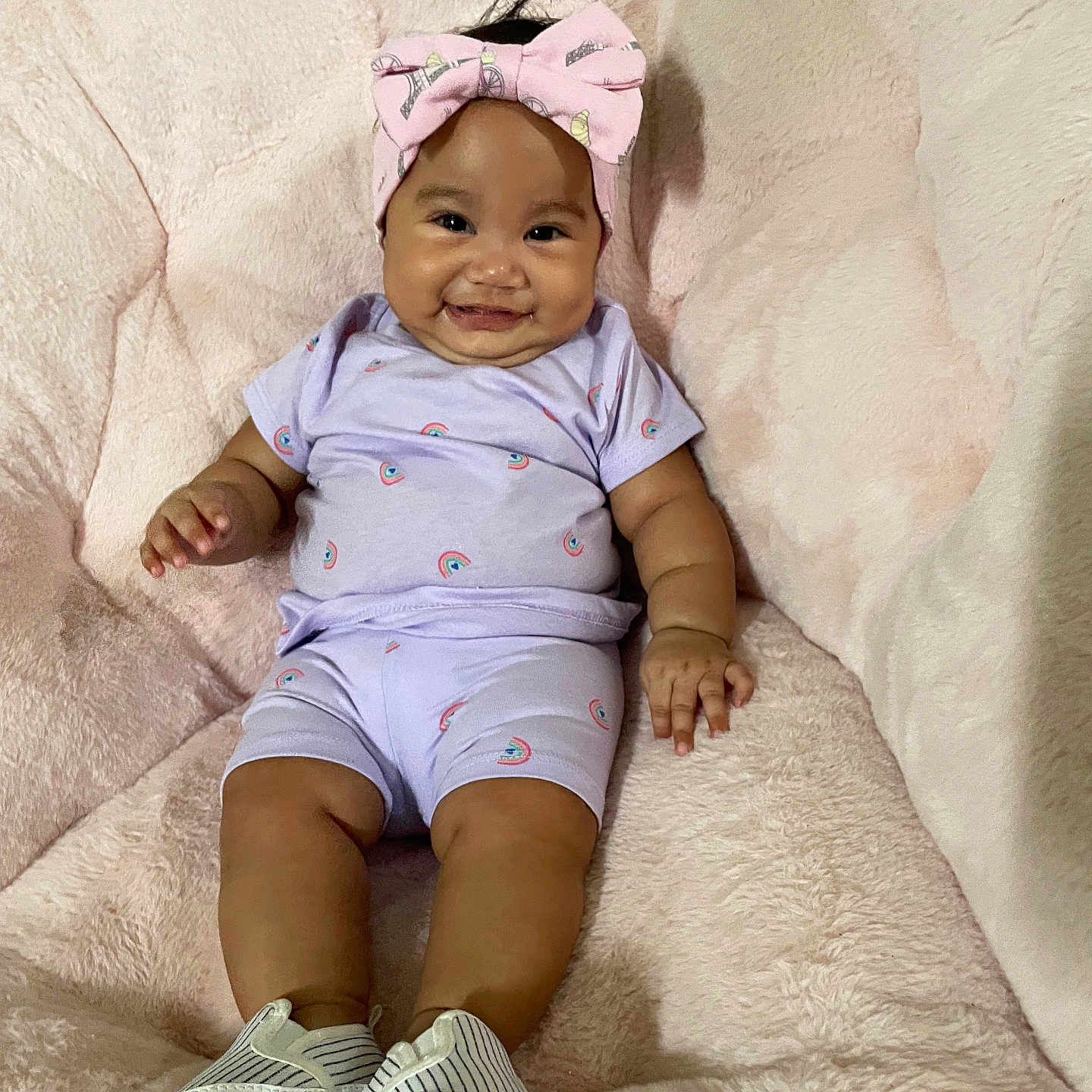 Zia Primo joined the competition — help win amazing prizes! baby, blanket, child, cute, fluffy, happy, headband, indoors, infant, person, pink_bow, portrait, purple_outfit, rainbow_print, shoes, sitting, smile, soft_texture, striped_shoes, young