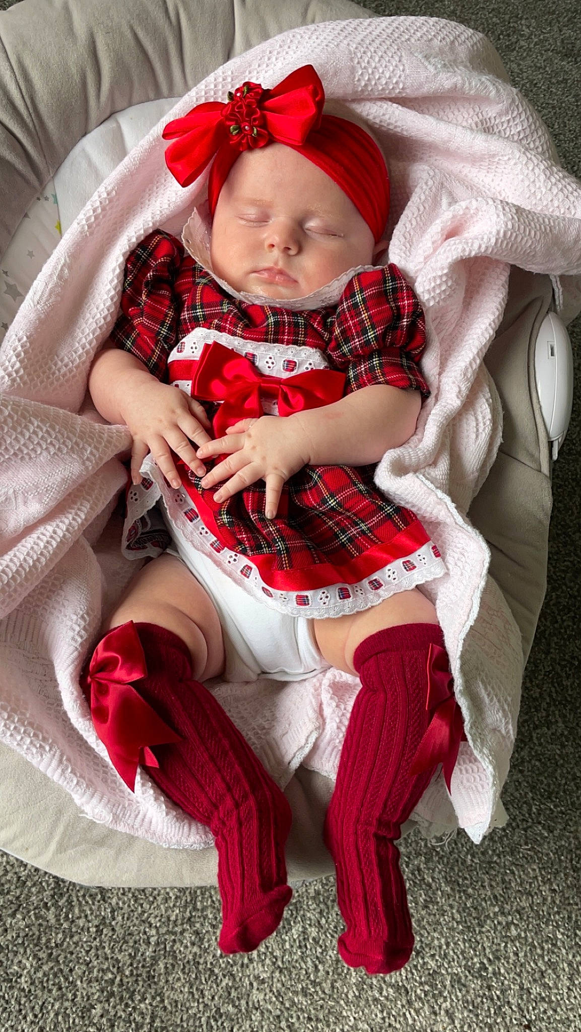 Darcie joined the competition — help win amazing prizes! baby, baby_toddler_clothing, child, christmas, comfort, costume_hat, face, fictional_character, hat, head, headwear, human_body, lap, pattern, person, plaid, sitting, sleeve, sock, tartan