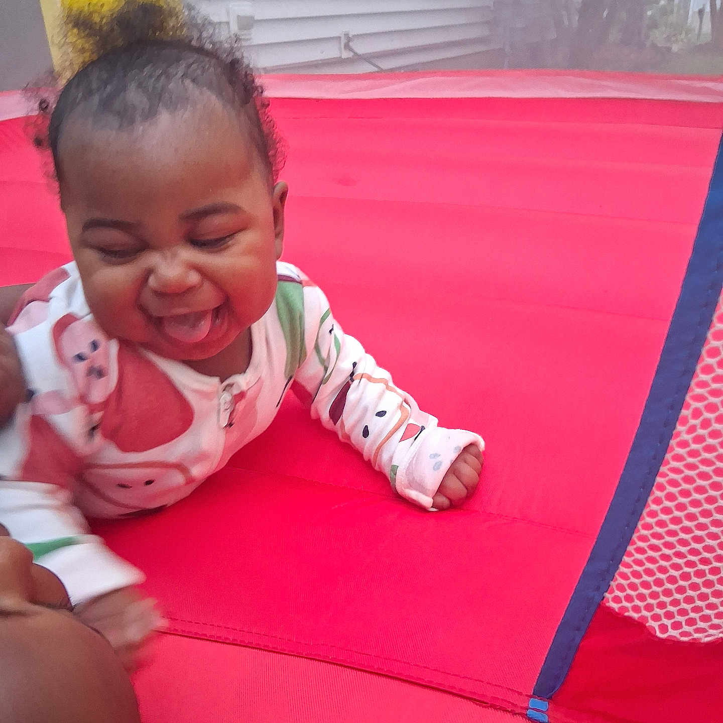 Naomi joined the competition — help win amazing prizes! baby, child, colorful_clothing, crawling, curly_hair, cute, face, fun, happy, indoor, infant, inflatable, joyful, laughing, pajamas, person, play, red_surface, smiling, tongue_out